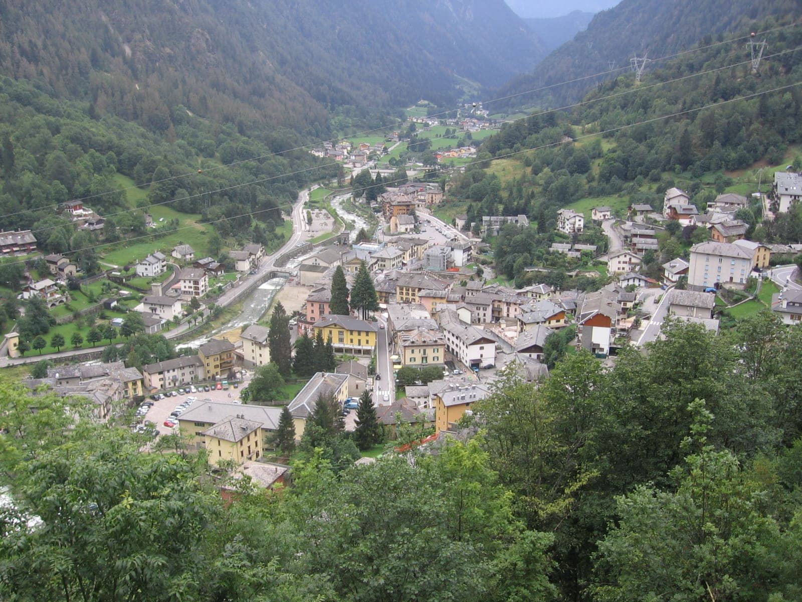 Il paese di Branzi visto dall'alto, con le case raccolte lungo il Brembo e i boschi dell'alta Valle Brembana